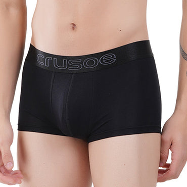 Man wearing black bamboo trunk briefs on a white background